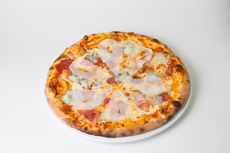 Freshly baked whole pizza with different cheesesの写真素材