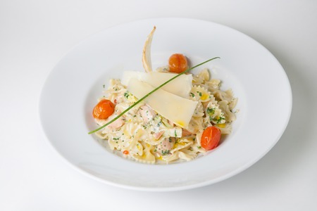 Pasta dish with cheese and red tomatoesの写真素材