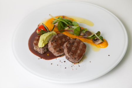 Mignon beef steak with potato garnish and sauceの写真素材