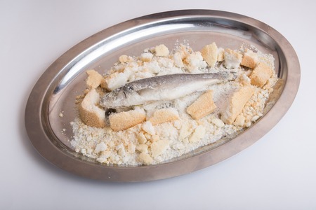 Fish baked in salt on a metal tray