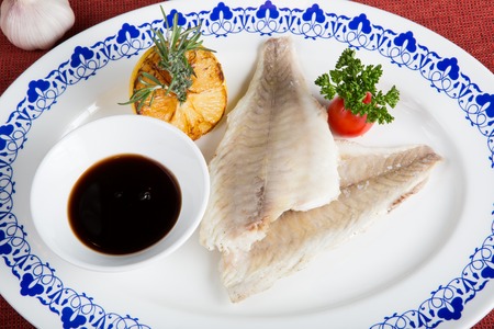 White fish fillet with soy sauce and herbs