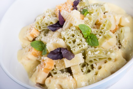 Pasta bowl with parmesan cheese and basil