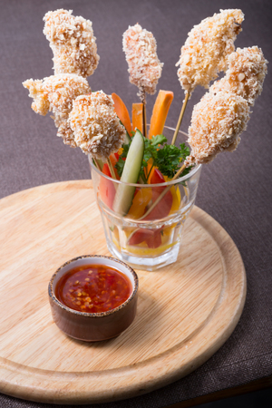 Fried chicken nuggets on a wooden skewersの写真素材