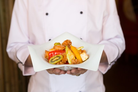 Cook holding plate with foodの写真素材