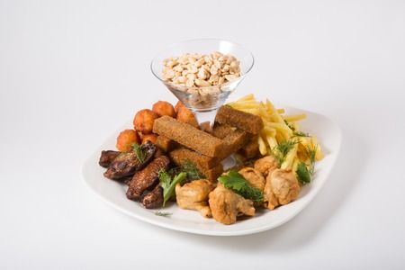 Different beer snacks on a white plateの写真素材