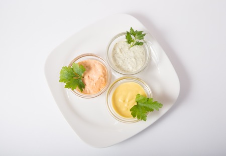 Three different sauces on a white backgroundの写真素材