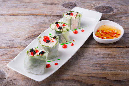 Spring roll with caviar, cucumber and cili sauce