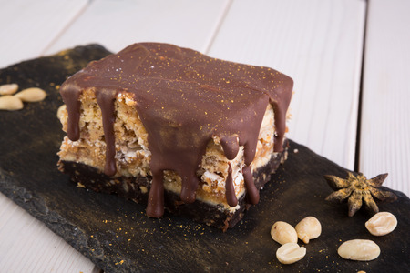 Piece of decorated chocolate cake with peanuts
