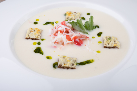 Crab cream soup served with croutons and herbsの写真素材