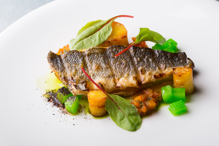 Grilled fish fillet with potato garnish and cucumbers,の写真素材