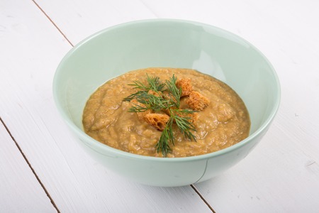 Vegetable cream soup served with croutons in a bowlの写真素材