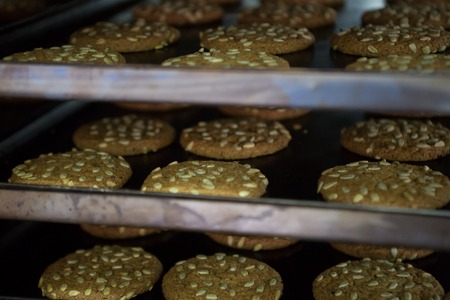 Modern bakery in confectionery factory. Industrial ovens for baking biscuits, cakes and cookies.の写真素材