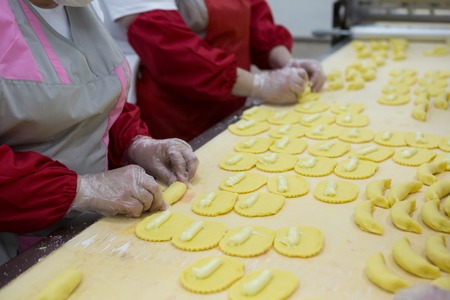 Modern bakery in confectionery factory. Industrial ovens for baking biscuits, cakes and cookies.