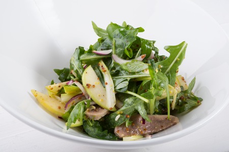 Green arugula salad with beef tongue and appleの写真素材