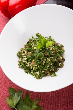 Lebanese tabbouleh salad served in a white bowlの写真素材