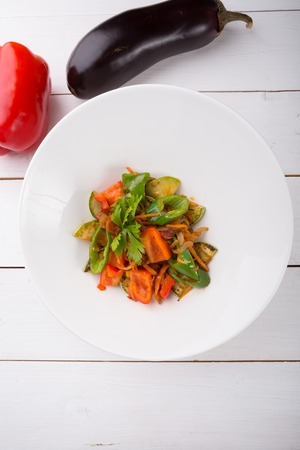 Mixed grilled vegetables salad served in a white bowlの写真素材