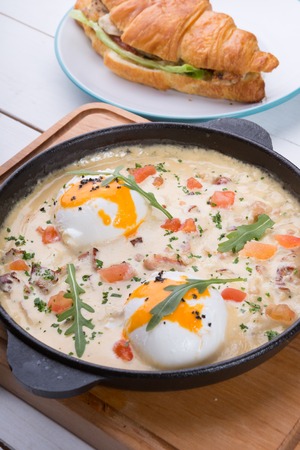 Stuffed croissant and shakshuka served for breakfast