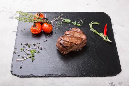 Prepared beef steak served with herbs and spicesの写真素材