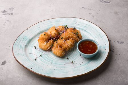 Fried shrimps in tempura served with spicy sauce