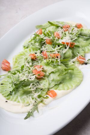 Fresh green ravioli served with parmesan cheeseの写真素材