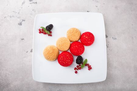 Dessert cakes served with berries and mint leaf