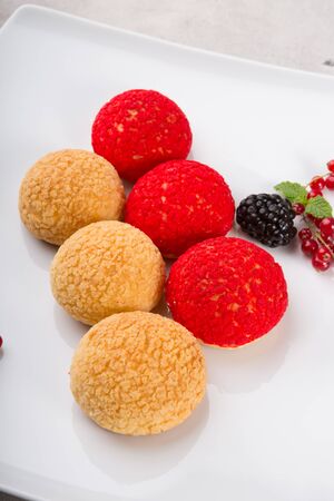Dessert cakes served with berries and mint leaf