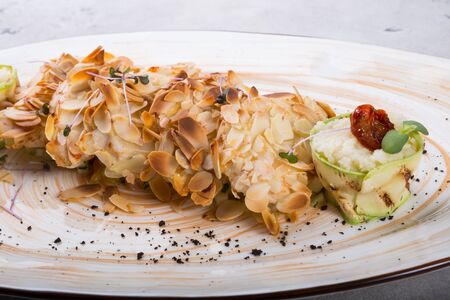 Chicken baked in almonds and served with steamed quinoaの写真素材