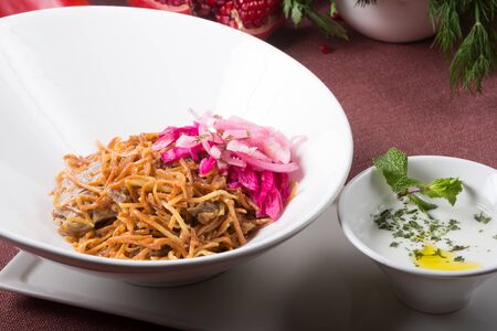 Bowl of noodles with meat and onionの写真素材