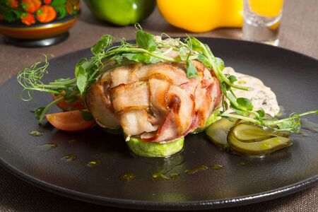 Fried bacon cutlet served with grilled zucchiniの写真素材