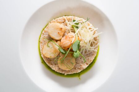 Scallops and shrimps served with brown riceの写真素材