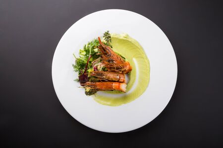 Fried king shrimps served with avocado sauceの写真素材