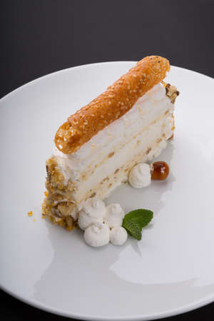 Slice of sweet merigue cake on white background