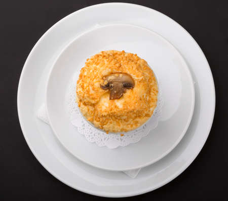 Baked mushroom covered with melted cheese served in white bowlの写真素材