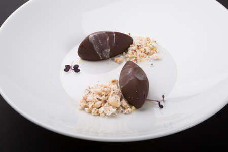 Decorated truffle chocolate dessert candy on white plate