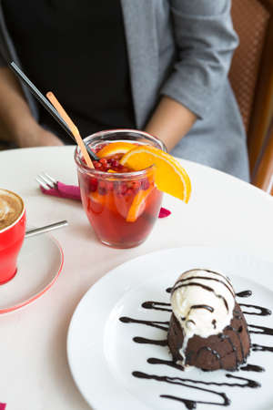 Winter cocktail and ice cream brownie served on a table