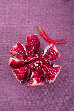 Red fresh pomegranate fruit on kitchen tableの写真素材