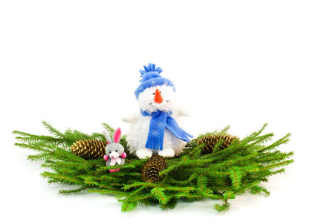 Christmas tree branches with snowman, golden cones and rabbitの写真素材