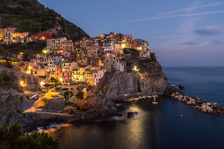 The small italian city Manarola over the sea at nighttimeの写真素材