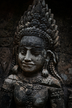 An ancient statue at the temples of Angkor Wat, Cambodiaの写真素材
