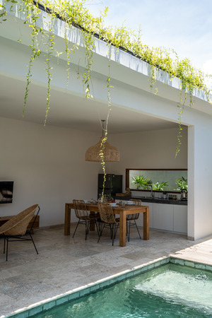 LOMBOK, INDONESIA - February  11 2019: A beautiful private dining area in the Kumbara villa in Kuta on the island of Lombok showing some wine bottles and a kitchenのeditorial素材