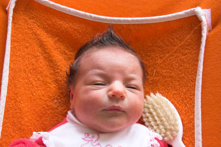 A baby with a punky hairstyle.の写真素材