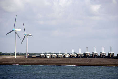 Two windmills and the Oosterscheldekering in Zeeland, Netherlandsの写真素材