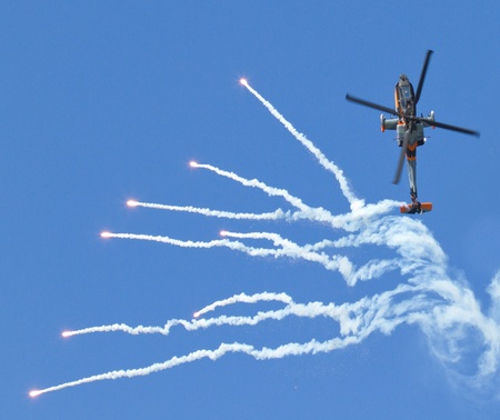 LEEUWARDEN,FRIESLAND,HOLLAND-SEPTEMBER 17:: Apache AH-64D Solo Display Team shoots flares at the Airshow on September 17, 2011 at Leeuwarden Airfield, Friesland, Holland.のeditorial素材