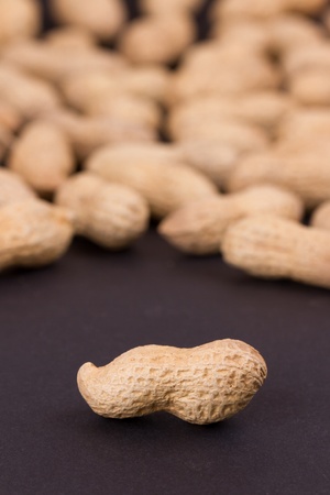 Roasted in-shell peanuts on a black backgroundの写真素材