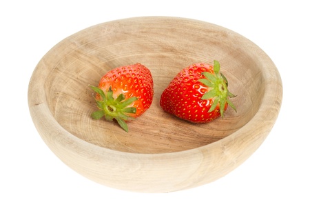 Two fresh strawberries in a wooden bowlの写真素材