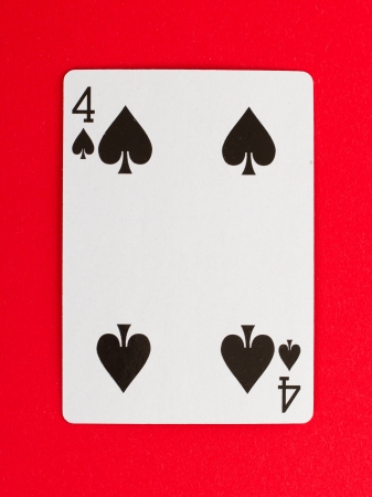 Old playing card (four) isolated on a red backgroundのeditorial素材