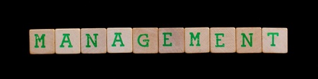 Green letters on old wooden blocks (management)の写真素材