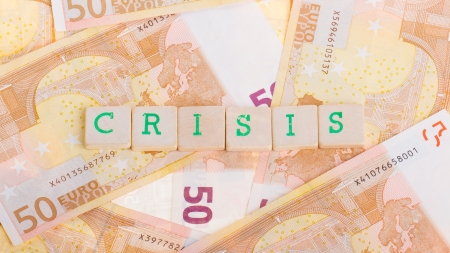 Letter on blocks on top of some 50 euro banknotes