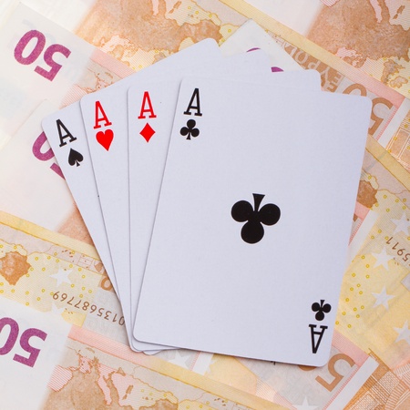 Four aces on top of some 50 euro banknotesのeditorial素材