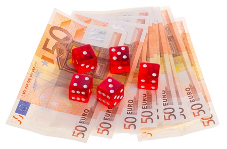 Red dice on top of some 50 euro banknotes